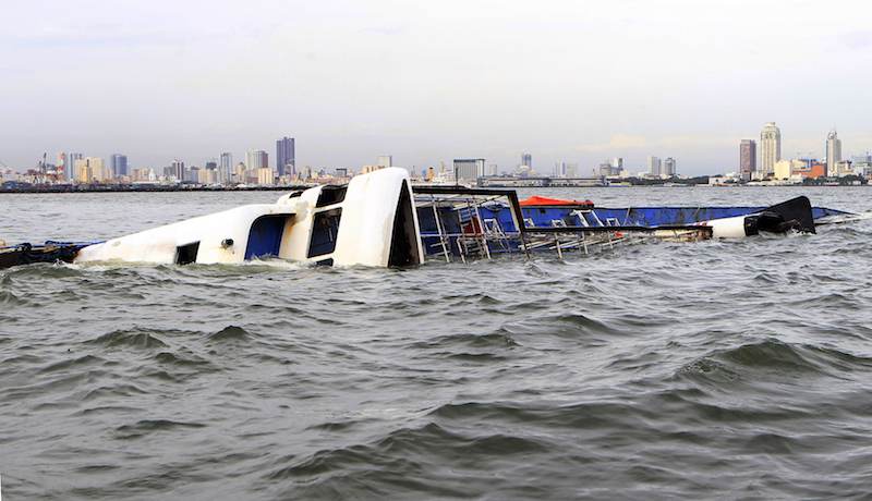 The Super Shuttle Ferry 7 floats on its side after it capsized in strong winds and huge waves unleashed by Typhoon Kalmaegi, locally named Luis, in Manila Bay